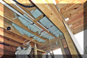 Applying spray foam in garage